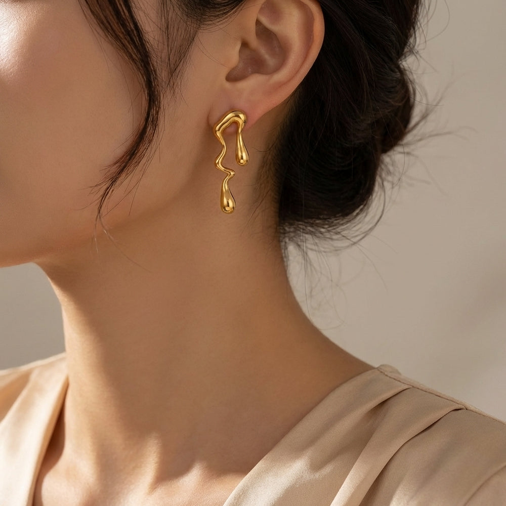 sculpted gold-plated stainless steel earrings with a modern fluid design